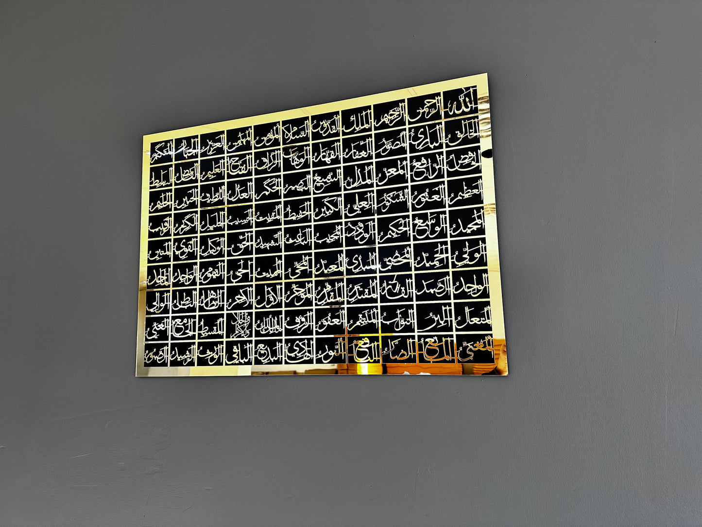 Asmaul Husna gold on black wall decor in interior setting