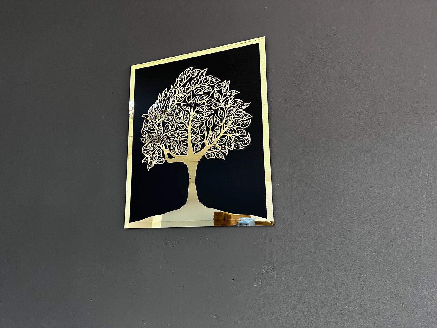 Gold acrylic Islamic tree of life wall art angled to show its mirrored surface