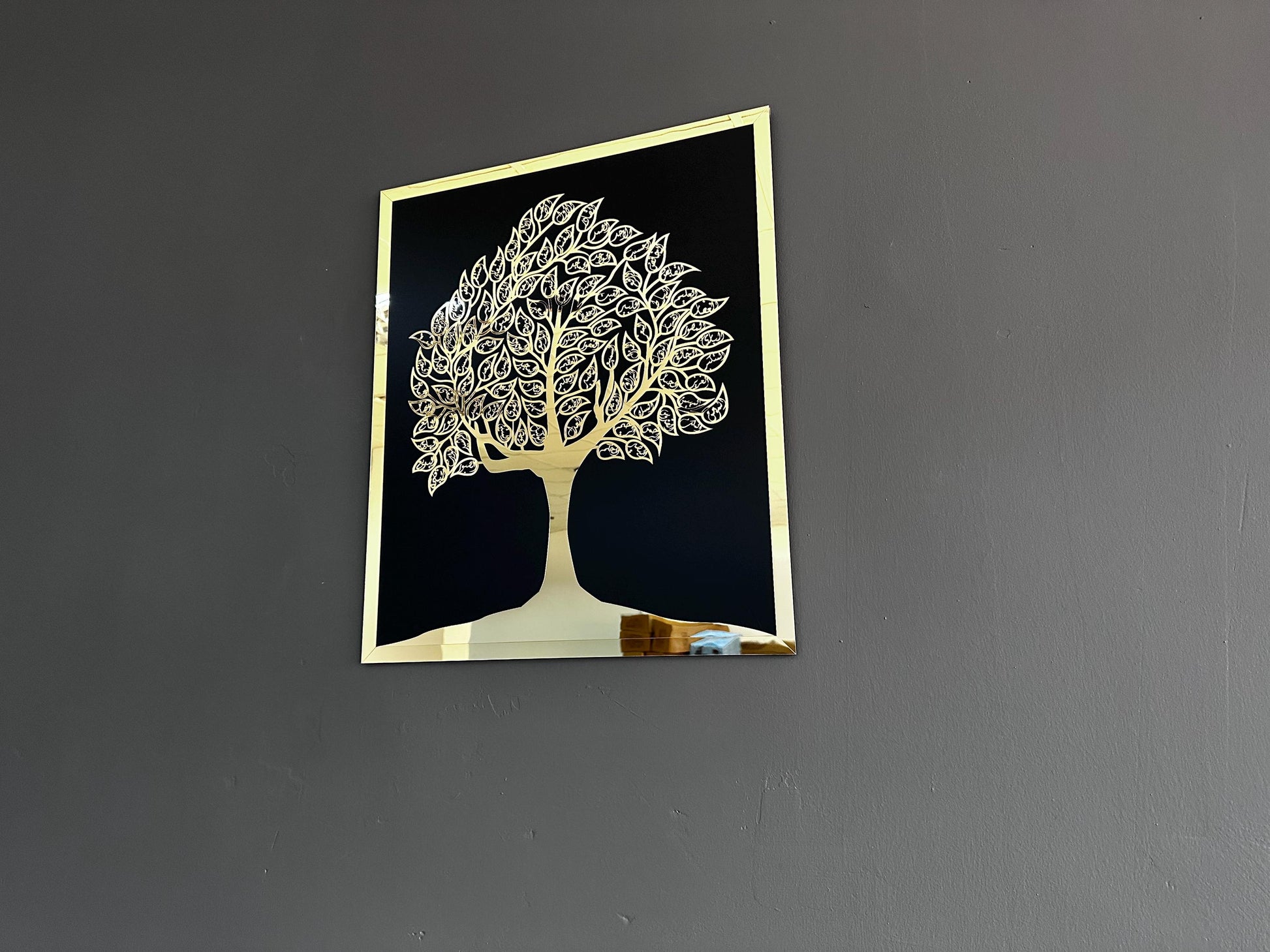 Gold acrylic Islamic tree of life wall art angled to show its mirrored surface